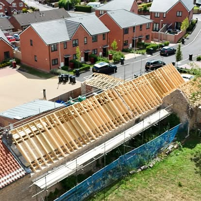 Roof trusses craned into position on extension walls
