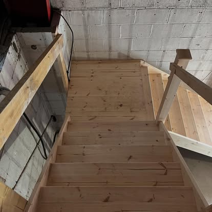 New pine staircase viewed from above in blockwork building