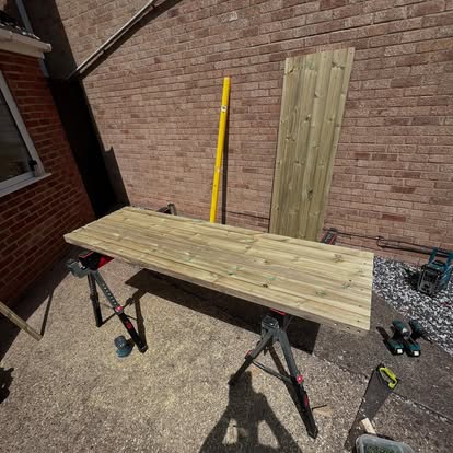 Timber gate frame on sawhorses being constructed