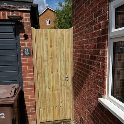 Completed vertical board timber side gate at house 97
