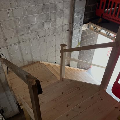 New pine staircase viewed from above in blockwork building