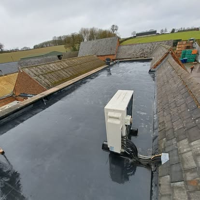 Aerial view of farm complex with dark EPDM flat roof