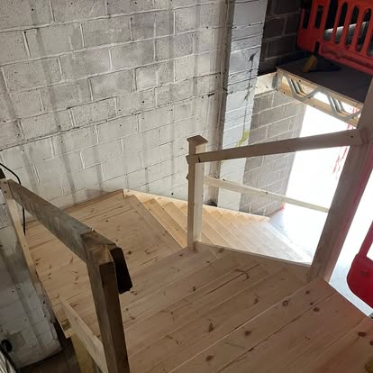 Pine staircase in blockwork building viewed from above