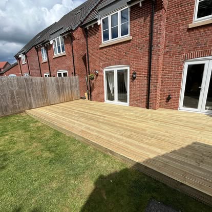 Large light timber deck spanning rear of new build house