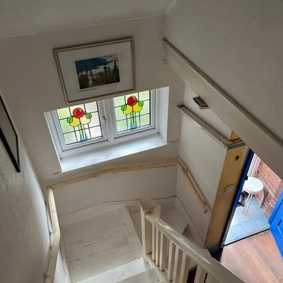 Staircase from above with stained glass window