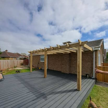Grey composite decking with pergola on bungalow
