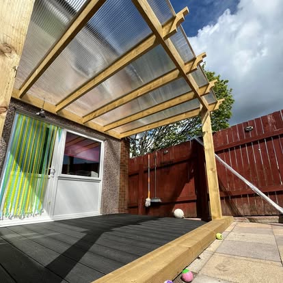 Composite decking with pergola and garden chairs