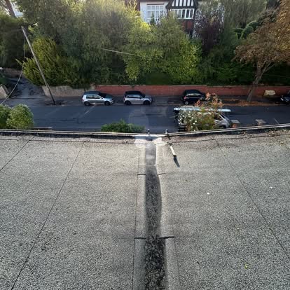View down from flat felt roof, guttering visible
