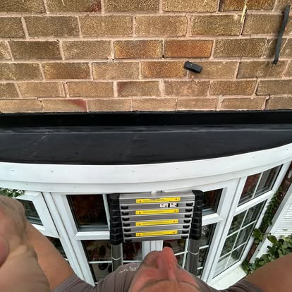 Bay window EPDM roof installation with ladder