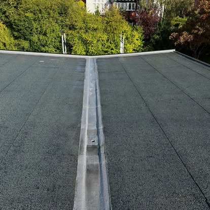 New EPDM flat roof next to old felt section