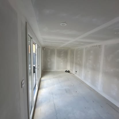 Freshly plastered extension room with bifold doors