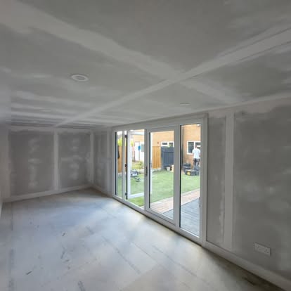 Freshly plastered extension room with bifold doors