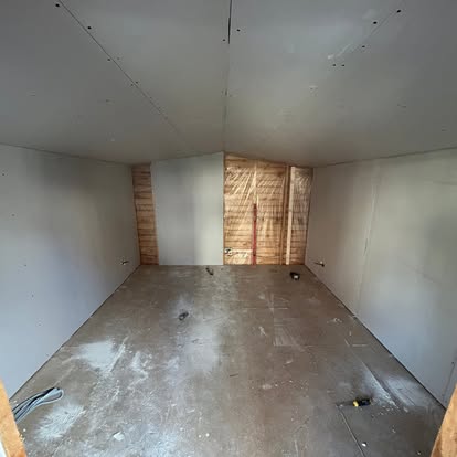 Small garden room interior at plasterboarding stage