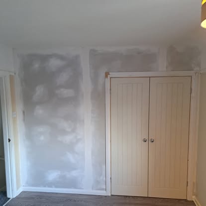 Bedroom replastering with built-in wardrobe and door