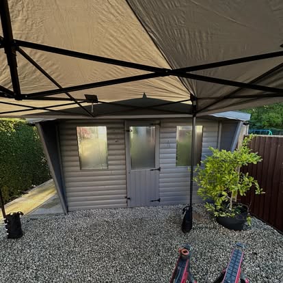 Grey garden room with canopy and gravel surround