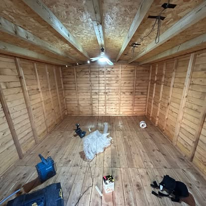Large raw pine interior of garden room, pendant light