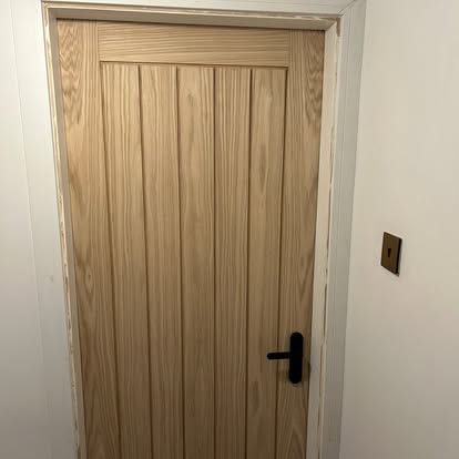 Oak T-and-G panel internal door with black handle