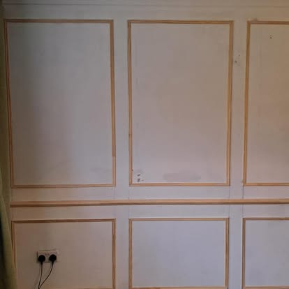 Wall panel moulding frames being fitted in lounge