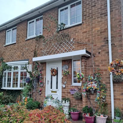 Brick house exterior with new white door canopy