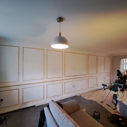 Living room wall panel mouldings at same stage