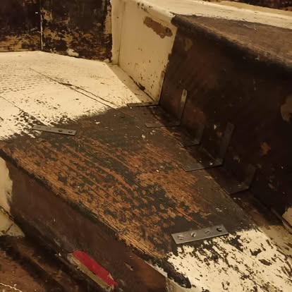 Old dilapidated painted timber stairs being repaired