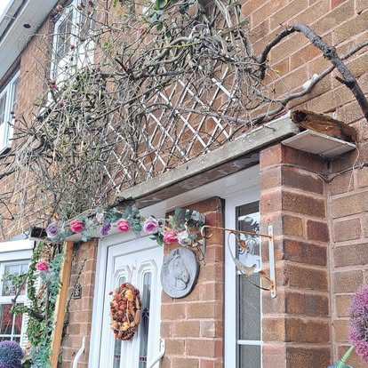 House before, old timber trellis above front door