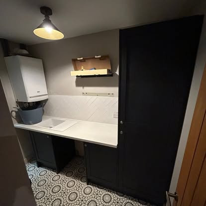 Completed navy utility room with patterned floor tiles