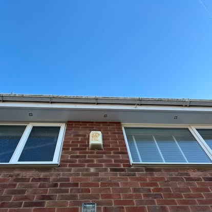 Brick house with new white fascia and guttering