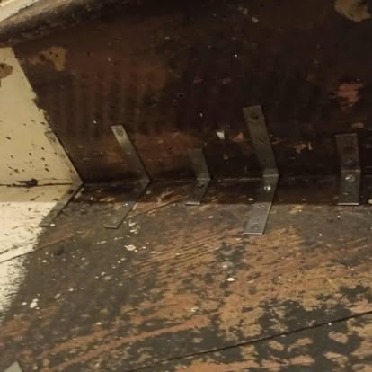 Old staircase close-up with metal angle brackets