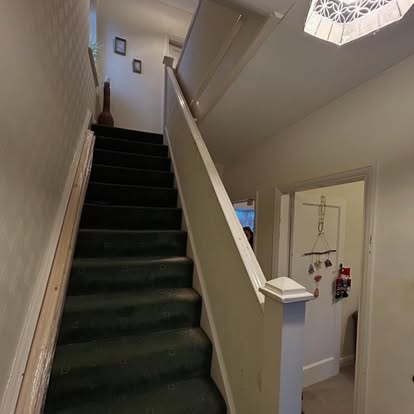 Staircase before renovation, old white balustrade