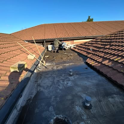 Flat roof installation with worker on roof