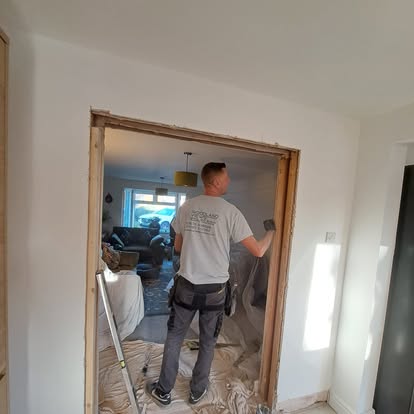 Worker in Woodland Views shirt in knocked-through wall