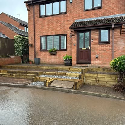 Front garden landscaping with timber sleeper terraces