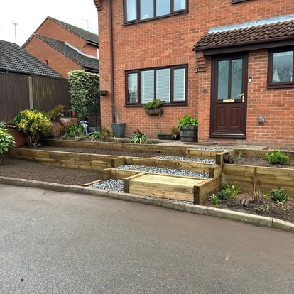 Gravel and timber sleeper terraces in front garden