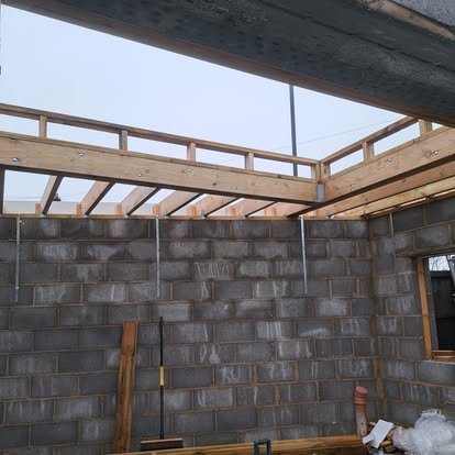 Block extension interior with breeze block walls and rafters