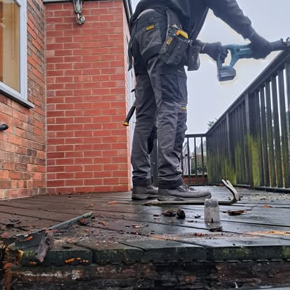 Worker on old rotted canopy being demolished