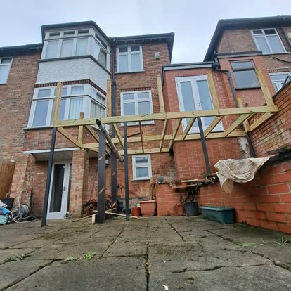 Elevated deck frame with timber joists partially boarded
