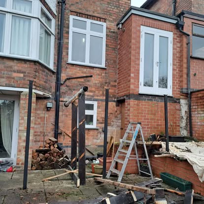 Steel posts and partial timber frame with patio below
